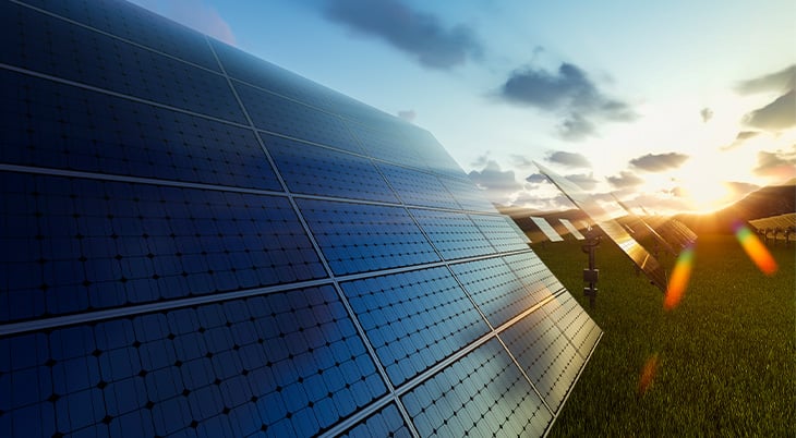 Solar panels with the sun in the background